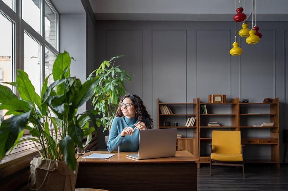 Happy woman thinks about her career success