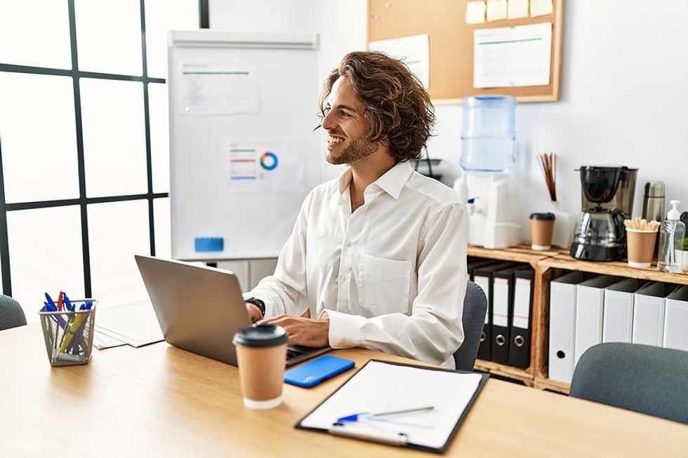 Man smiles at work