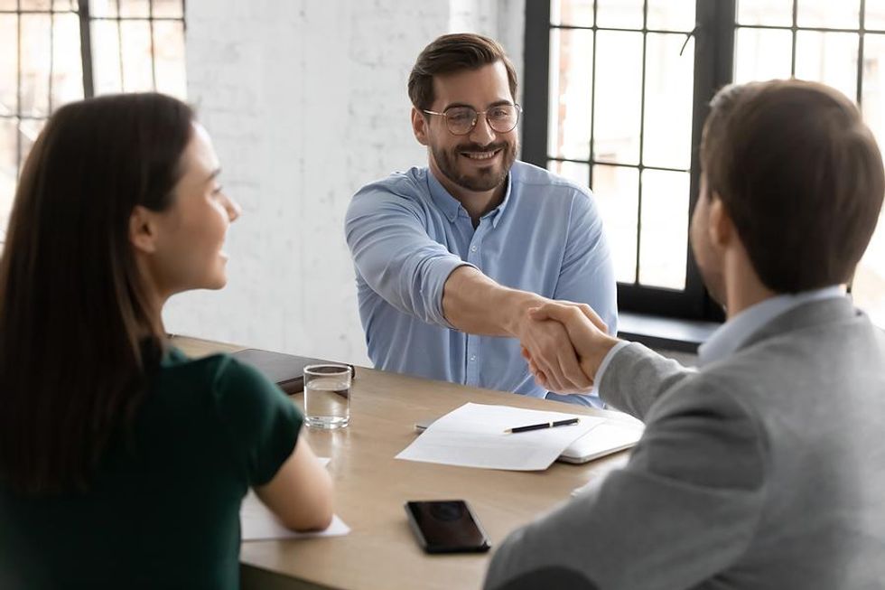 Man shakes hands with the hiring manager before his job interview