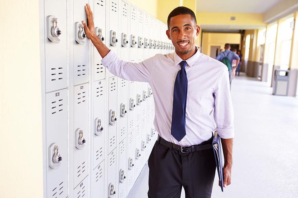 Teacher stands in the school hallway