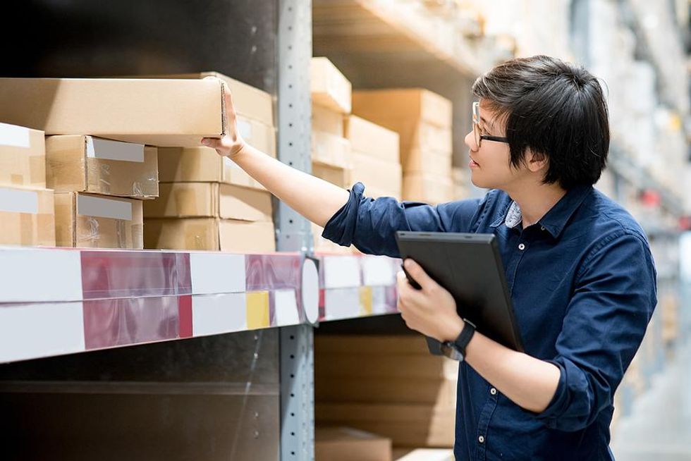 Man checks for a product in a warehouse