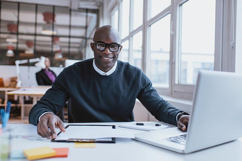 Man smiles while working