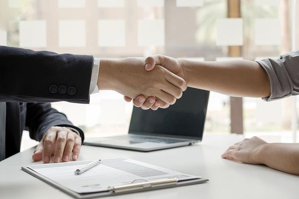 People shake hands before an interview